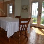 The original wide plank pine floors add warmth to the bright and cozy diningroom.