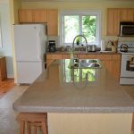 Large, bright open concept kitchen with centre island.