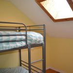 The third bedroom at Cielo Farm Cottage has bunk beds and a skylight.
